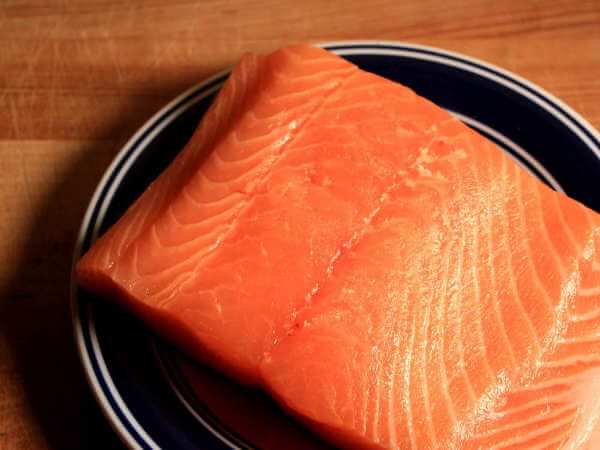 Raw Atlantic Salmon Fillet On Blue Bordered Plate